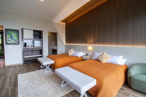 a bedroom with three beds and a couch at Lucero Residences Golf & Wellness Resort in Boquete