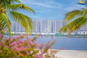 a bridge over a body of water with tall buildings at Luxury 1BR Apartment - Ocean Lake View - Vinhomes Ocean Park in Gia Lâm Pho