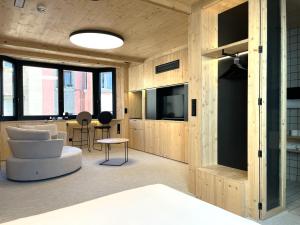 a living room with a white couch and a tv at VTZ Minimal Suites in Zaragoza