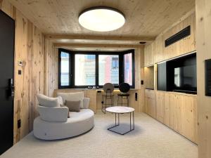 a living room with a white couch and a table at VTZ Minimal Suites in Zaragoza