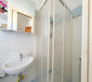 a bathroom with a sink and a shower at La stanza di Giuly in Porto Santo Stefano +7 photos