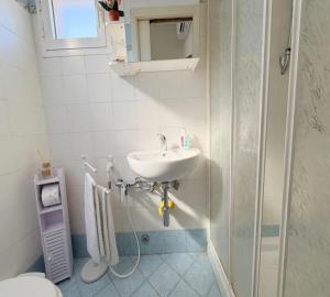 a bathroom with a sink and a toilet at La stanza di Giuly in Porto Santo Stefano