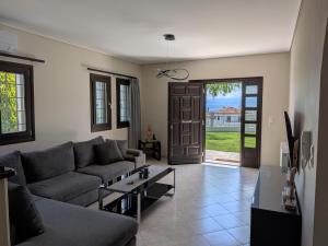 a living room with a couch and a table at Homezie AGRIA in Agria