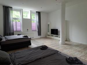 a living room with two beds and a television at Fewo Wuppertal in Wuppertal