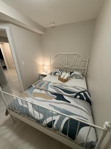 a bedroom with a bed with a metal frame at The Urban Nest 2 in Calgary