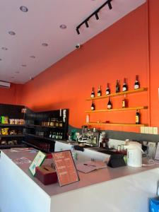 a restaurant with an orange wall and a counter at Azure Edge in Dauis