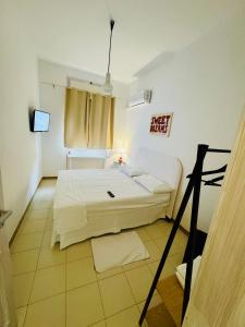 a bedroom with a large white bed and a window at B&B Del Popolo in Torre Chianca +25 photos
