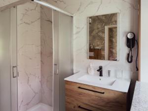 a bathroom with a sink and a shower at Restauracja i Hotel KUBUŚ in Bełchatów +66 photos