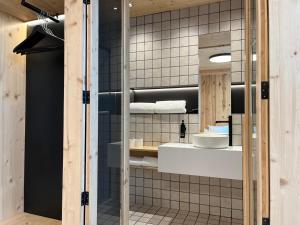 a bathroom with a sink and a mirror at VTZ Minimal Suites in Zaragoza