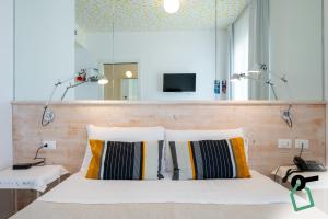 a bedroom with two pillows on a bed at Hotiday Porto Cesareo Laguna in Porto Cesareo