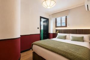 a bedroom with a large bed and a window at Casa Lavanda by Blossom Hotels in Granada