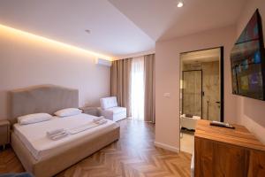 a hotel room with a bed and a television at Hotel Almar in Sarandë