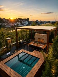 a patio with a pool and a table and a fireplace at Light House Villa in Da Lat