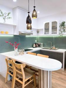 a kitchen with a large white table and chairs at Minh Anh Apartment 5 in Thôn Văn Dương