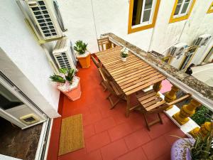 an overhead view of a patio with a wooden table and chairs at Very Typical - Alojamento Local in Elvas
