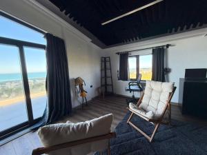 a living room with a view of the ocean at MarinaBlueGarden34 in Karaburun