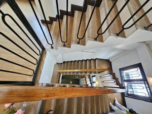a staircase in a house with wooden walls at Serene Residence in Vientiane