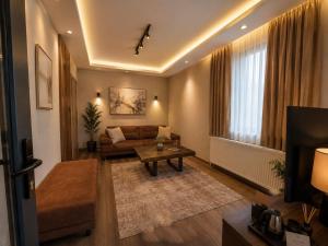 a living room with a couch and a table at MarinaBlueGarden34 in Karaburun