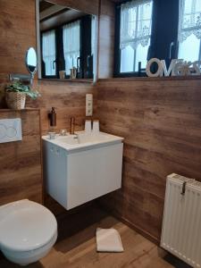 a bathroom with a white sink and a toilet at Côté Cosy in Marche-en-Famenne +39 photos