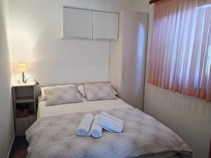 a bedroom with two beds with towels on them at Apartmani Matjačić - Ugljan in Ugljan