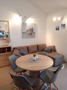a living room with a table and a couch at Apartmani Matjačić - Ugljan in Ugljan