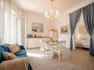 a living room with a blue couch and a table at Nido Blu in Polignano a Mare +13 photos