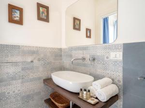 a bathroom with a sink and a mirror at Nido Blu in Polignano a Mare
