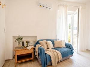 a living room with a blue couch and a table at Nido Blu in Polignano a Mare