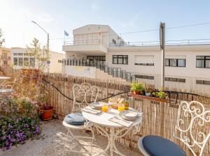 a table and chairs on a balcony with a building at Nido Blu in Polignano a Mare