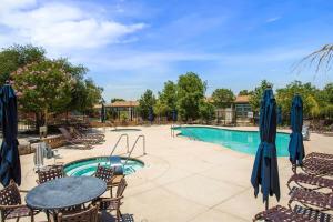 a patio with a table and chairs and a pool at Ranch House at Galway Downs in Temecula +20 photos