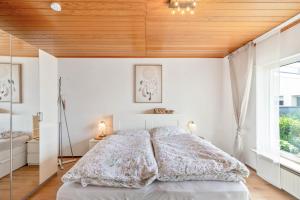 a bedroom with a bed with a wooden ceiling at Zipper Burgblick Otzberg Odenwald in Hering