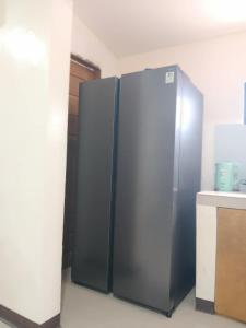 a large stainless steel refrigerator in a kitchen at Zoldyck Villa 1 in Bacolod +1 photo