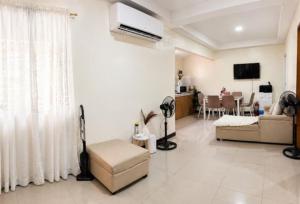 a living room with a couch and a dining room at Zoldyck Villa 1 in Bacolod