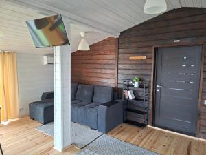 a living room with a couch and a tv at Scandidim Lutsk in Lutsk