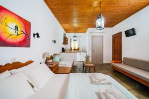 a living room with a bed and a couch at Giola Bungalows Sirines in Astris
