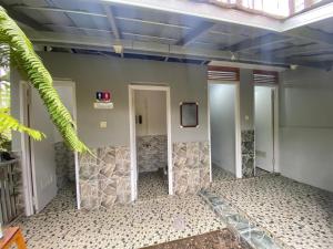 a hallway in a building with a tv on the wall at corak alam glamping in Tangkubanperahu +35 photos