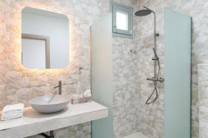 a bathroom with a sink and a shower at Giola Bungalows Sirines in Astris