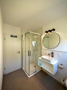 a bathroom with a shower and a sink and a mirror at Heimatblick Fulda in Fulda +107 photos