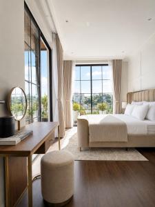 a bedroom with a bed and a desk and window at Light House Villa in Da Lat +37 photos