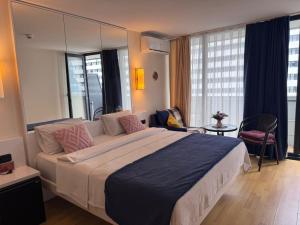 a bedroom with a large bed with a large mirror at Orbi in Batumi 24 in Angisa
