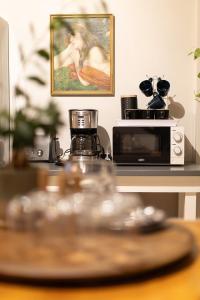 a table with a microwave and a picture of a woman at Lagoon Views in Knysna