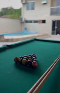 a group of billiard balls on a pool table at Hospedagem Doce lar in Joinville +8 photos
