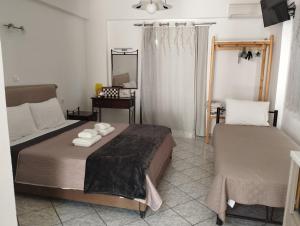 a bedroom with a bed and a mirror at Manganas Studios in Paleokastritsa