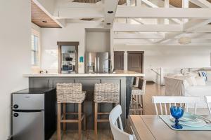 a kitchen and living room with a table and chairs at Captain's Quarters in Smithville
