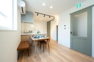 a kitchen and dining room with a table and chairs at HIKARIE Modern Stay Toyama in Toyama