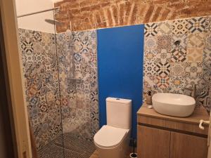a bathroom with a toilet and a sink at D. TERESINHA in Vila de Frades +70 photos