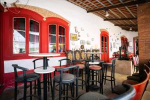 a room with tables and stools in a restaurant at D. TERESINHA in Vila de Frades