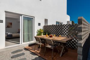 a dining room with a table and chairs on a balcony at Nikos Hotel in Karterados