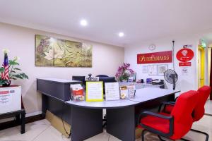 a counter in a store with a red chair at Puteri Ampang Hotel in Ampang
