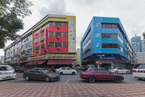 a parking lot with cars parked in front of buildings at Puteri Ampang Hotel in Ampang